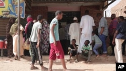 FILE -People line up in front of a bakery during a cease-fire in Khartoum, Sudan, May 27, 2023. (AP Photo/Marwan Ali, File)