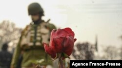 An Indian paramilitary trooper stands guard during a protest attended by former Chief Minister Omar Abdullah to demand justice for the recent killings of two civilians who died during a security operation by government forces, in Srinagar on Nov. 18, 2021.