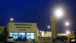 FILE - Guards stand outside the entrance to the Greensville Correctional Center, where executions are carried out, in Jarratt, Va., Sept. 23, 2010. Virginia's House on Feb. 5, 2021, pass a bill that would end the death penalty in the state.