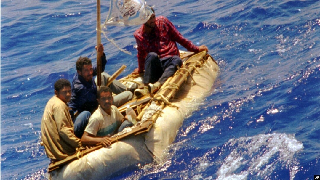 FILE - Cuban refugees float in heavy seas 60 miles south of Key West, Florida, Aug. 26, 1994.
