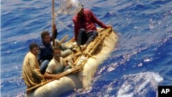 FILE - Cuban refugees float in heavy seas 60 miles south of Key West, Florida, Aug. 26, 1994.