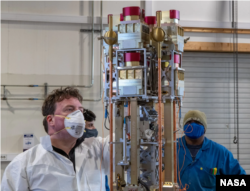 Glyn Collinson, leader of NASA's Endurance mission, reviews the instrument used to confirm the existence of the ambipolar electrical field during a rocket reassembly operation on site in Svalbard, Norway. (Image Credit: NASA Wallops/Brian Bonsteel)