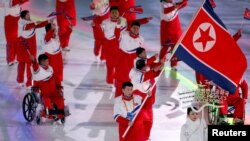 Jong Hyon Kim of North Korea carries the national flag during the opening ceremony, March 9, 2018, at the Pyeongchang 2018 Winter Paralympics in Pyeongchang, South Korea.