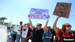 Immigrant rights advocates protest near the U.S.-Mexico border over a visit by U.S. Attorney General Jeff Sessions and Secretary of Homeland Security John Kelly in San Ysidro, a district of San Diego, California, April 21, 2017. 