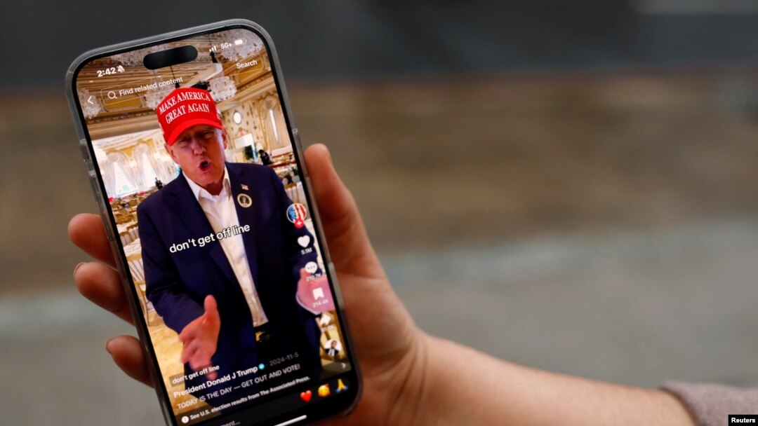 Žena pozira sa svojim pametnim telefonom prikazujući @ realdonaldtrump TikTok stranicu, Vašington, 19. januar, 2025. (Foto: REUTERS/Shannon Stapleton)
