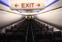 Rows of empty seats on an American Airline flight are seen, as coronavirus disruption continues across the global industry, during a flight between Washington, D.C., and Miami, in Washington, ,March 18, 2020.