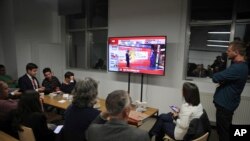 FILE - Journalists watch as preliminary results are announced after the local elections, in Istanbul, March 31, 2019.