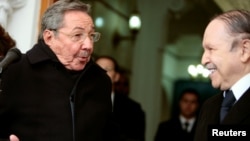 FILE PHOTO: On Feb. 8, 2009, Cuba's President Raul Castro, left, looks to his Algerian counterpart Abdelaziz Bouteflika at the presidential palace in Algiers. 