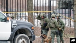 Police work outside the Molson Coors Brewing Co. campus in Milwaukee, Wisconsin, Feb. 26, 2020, after reports of a shooting.