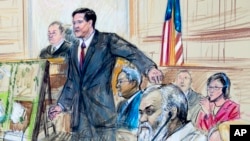 FILE - This courtroom sketch depicts Ahmed Abu Khattala listening to a interpreter through earphones during the opening statement by Assistant U.S. Attorney John Crabb, second from left, at federal court in Washington, Oct. 2, 2017. 