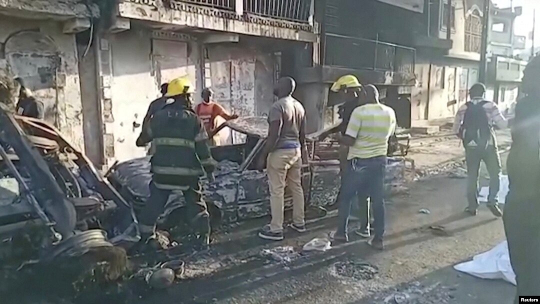 People stand at the site of an explosion in Cap-Haitien, Haiti, Dec. 14, 2021, in this still image obtained from Reuters TV footage.