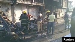 People stand at the site of an explosion in Cap-Haitien, Haiti, Dec. 14, 2021, in this still image obtained from Reuters TV footage.