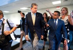 Sen. Joe Manchin, D-W.Va., is followed by reporters after a closed-door meeting on Capitol Hill with other Democrats in the bipartisan talks, in Washington, June 22, 2021.