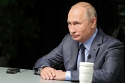 FILE - Russian President Vladimir Putin gives an interview in Sochi, Russia, in this undated photo released Oct.13, 2019. (Sputnik/Mikhail Klimentyev/Kremlin via Reuters)
