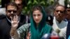 Maryam Nawaz, center, the daughter of former Pakistani prime minister Nawaz Sharif, talks with media following an appearance before a panel investigating the Sharif family's offshore companies and claims of money laundering, in Islamabad, July 5, 2017.