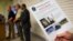 Charleston Emergency Management Director Mark Wilbert holds a flier distributed to media with surveillance footage of a suspect wanted in connection with a shooting Wednesday at Emanuel AME Church, in Charleston, S.C., June 18, 2015.