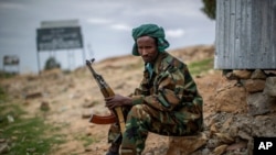 FILE - A fighter loyal to the Tigray People's Liberation Front mans a guard post on the outskirts of the town of Hawzen, then-controlled by the group but later re-taken by government forces, in the Tigray region of northern Ethiopia, May 7, 2021.