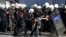Turkish riot police detain protesters rallying against what they see as Turkey's inaction against Islamic State militants moving against Kurds in Syria, close to Turkey's border, in Ankara, Oct. 7, 2014.
