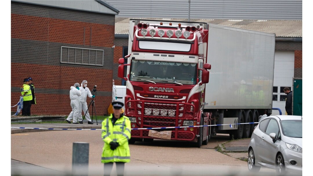 FILE - Police forensics officers attend the scene after a truck was found to contain the bodies of 39 refugees, in Thurrock, South England, Oct. 23, 2019.