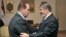 In this photo released by Middle East News Agency, caretaker Prime Minister Kamal el-Ganzouri, left, shakes hands with newly elected President Mohamed Morsi in Cairo, June 25, 2012.