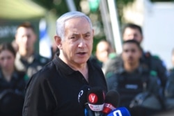 FILE - Israeli Prime Minister Benjamin Netanyahu meets with Israeli border police, in Lod, near Tel Aviv, May 13, 2021.