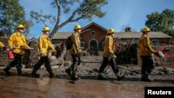 Rescue workers enter properties to look for missing persons after a mudslide in Montecito, California, Jan. 12, 2018. 