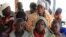 Mothers and children, refugees from from Democratic Republic of Congo, wait to be registered by UNHCR personnel, in Ntoroko, Uganda, Feb. 17, 2018.