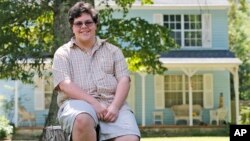 FILE - Transgender high school student Gavin Grimm poses in front of his home in Gloucester, Va., Aug. 22, 2016. The Supreme Court will take up transgender rights for the first time in the case of a Virginia school board that wants to prevent Grimm, a transgender teenager, from using the boys' bathroom at his high school.