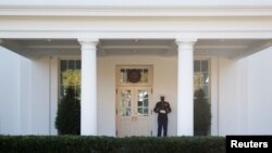 A United States Marine stands guard in front of the west wing of the White House, Nov. 6, 2020.