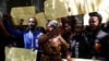 Protesters hold placards as they demonstrate against what they say is a wave of unexplained abductions of government critics, along Kimathi Street in downtown Nairobi, Kenya, Jan. 6, 2025. 