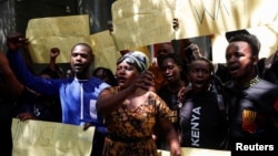 Protesters hold placards as they demonstrate against what they say is a wave of unexplained abductions of government critics, along Kimathi Street in downtown Nairobi, Kenya, Jan. 6, 2025. 