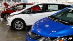 FILE - Several Chevrolet Bolt EV vehicles are shown during a tour of the General Motors Orion Assembly plant in Orion Township, Michigan, Nov. 4, 2016. 