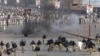 Police chase protesters during an anti-U.S. rally in Peshawar, Pakistan, September 21, 2012. 