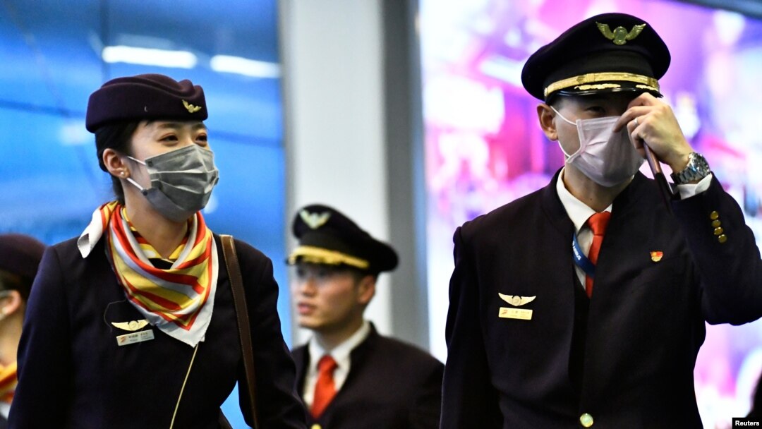 A flight crew arrives from China, after Canada began asking a screening question for visitors and displaying messages in several airports urging travelers to report flulike symptoms, at Vancouver International Airport, British Columbia, Jan. 24, 2020.