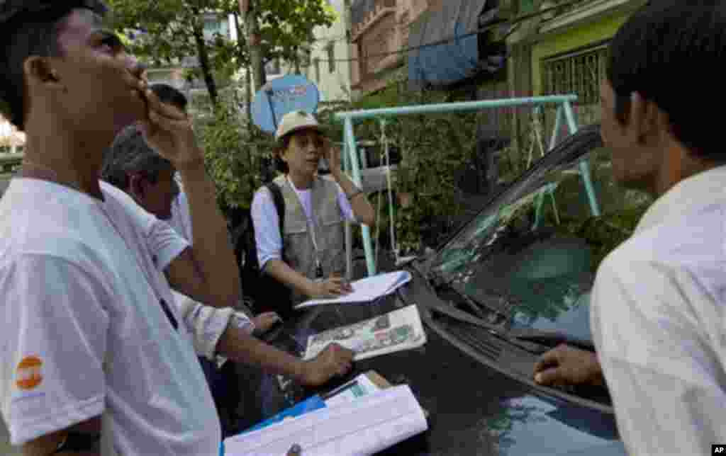 A Myanmar census enumerator and volunteers speak to a man, right, in a Muslim neighborhood in Yangon, Myanmar, Sunday, Mar 30, 2014. Enumerators fanned out across Myanmar on Sunday for a census that has been widely criticized for stoking religious and eth