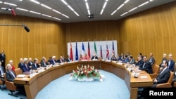 FILE - Participants in the Iran nuclear talks that culminated in the signing of the Joint Comprehensive Plan of Action are pictured during a meeting at the U.N. building in Vienna, Austria, July 14, 2015.