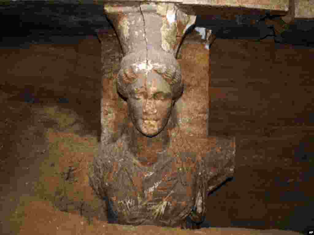 A photo shows a 60 centimeter (2 foot) female figurine on a wall leading to the yet unexplored main room of an ancient tomb, in the town of Amphipolis, northern Greece, released by the Greek Culture Ministry, Sept. 7, 2014.