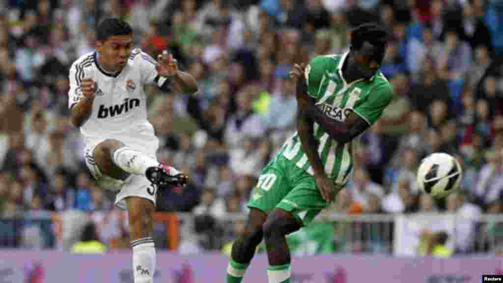 Real Madrid's Carlos Henrique Casemiro from Brazil, left, in action with Betis'  Nosa Igiebor from Nigeria, right, during a Spanish La Liga football match, Saturday, April 20, 2013.
