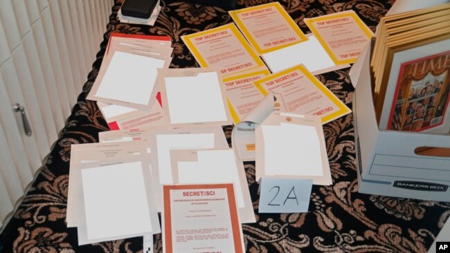 FILE - This image contained in a court filing by the Department of Justice on Aug. 30, 2022, and partially redacted by the source, shows a photo of documents seized during the Aug. 8, 2022, FBI search of former President Donald Trump's Mar-a-Lago estate.