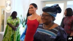 FILE— Meghan, the Duchess of Sussex, left, walks alongside Ngozi Okonjo-Iweala, right, Director-General of the World Trade Organization, during an event in Abuja, Nigeria,May 11, 2024.