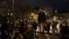 French believers stand and chant religious songs in front of Saint Sulpice Catholic church, in Paris, Nov. 13, 2020.