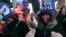Tatiana Rakotovazaha, from Madagascar, foreground left, Aurielle Williams, from Kansas, center, and Yayoi Okayama, from Japan, foreground right, dance as they take part in the New Year's Eve festivities in New York's Times Square on Dec. 31, 2012.