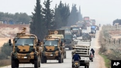 A Turkish military convoy is seen moving through eastern Idlib province, Syria, Feb. 28, 2020, a day after 33 Turkish soldiers were killed in the province in an airstike by Syrian government forces.