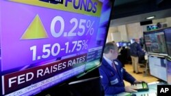 Specialist Edward Loggie works at his post on the floor of the New York Stock Exchange as the rate decision of the Federal Reserve is announced March 21, 2018.