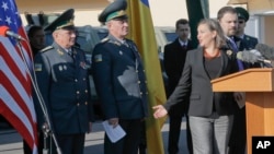 Assistant Secretary for European and Eurasian Affairs Victoria Nuland, second right, talks with Ukrainian border guard generals during her visit in a State Border Guard Service in Kiev, Ukraine, Oct. 8, 2014.