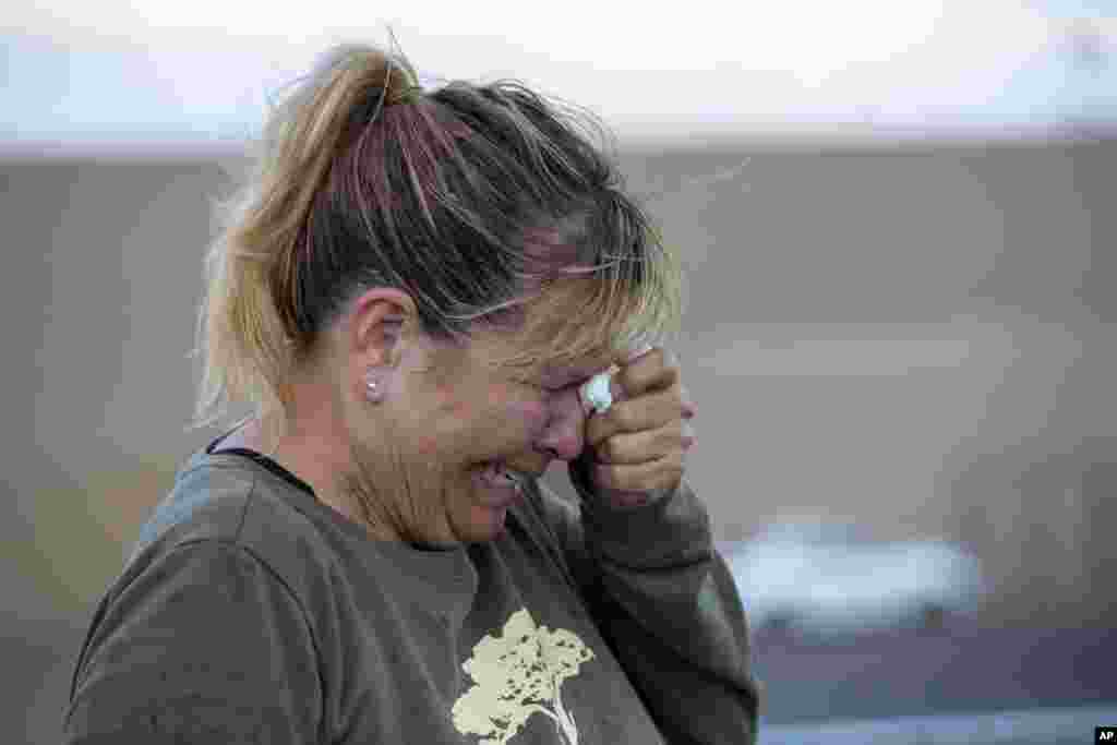 Edie Hallberg cries while speaking to police outside a Walmart store where a shooting occurred earlier in the day in El Paso, Texas, Aug. 3, 2019. Hallberg looked for her missing mother Angie Englisbee, who was in the store during the attack.