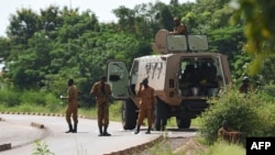 FILE - Burkinabe soldiers patrol near the Presidential Security Regiment military barracks in Ouagadougou, Sept. 29, 2015. Suspected jihadists reportedly killed several dozen people in an attack in eastern Burkina Faso on May 3, 2021.