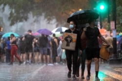 Protesters march in the rain, as protests against the death in Minneapolis police custody of George Floyd continue, in Washington, June 5, 2020.