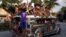 FILE - Residents ride on top of an overcrowded "jeepney", a locally manufactured public transport, along a highway in Mogpog town on Marinduque island in central Philippines, April 8, 2015. 