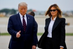 FILE - President Donald Trump walks with first lady Melania Trump at Cleveland Hopkins International Airport in Cleveland, Ohio, Sept. 29, 2020.